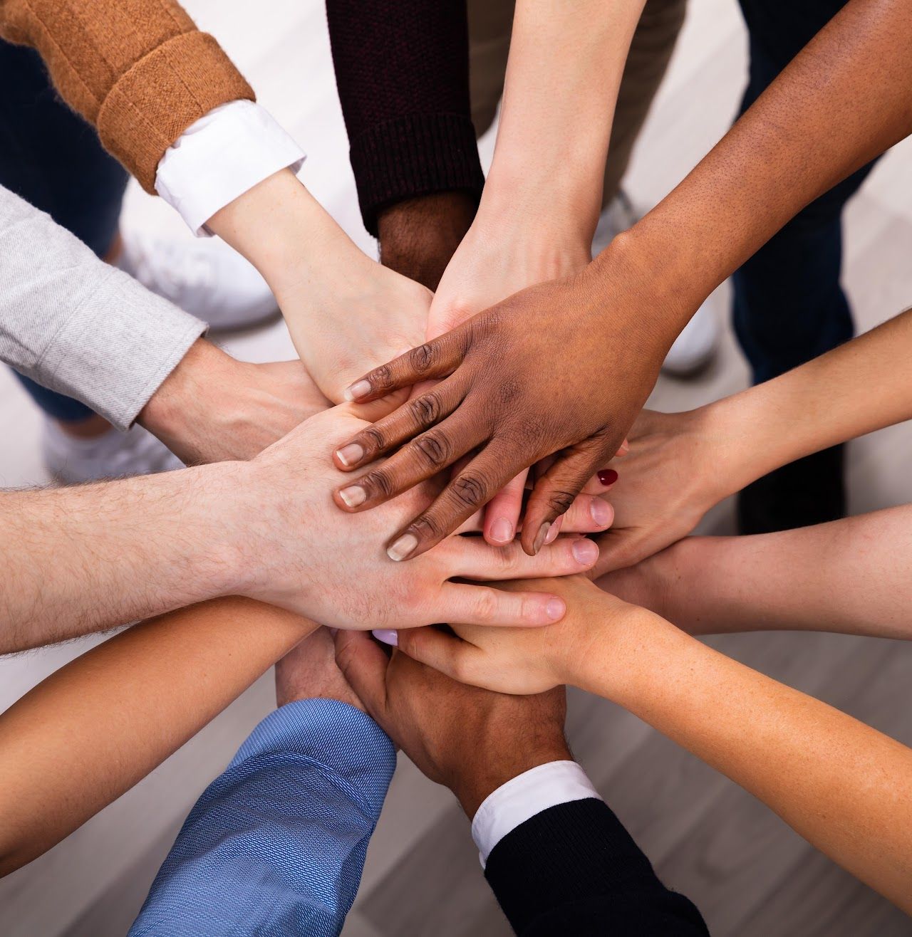 Team members joining hands